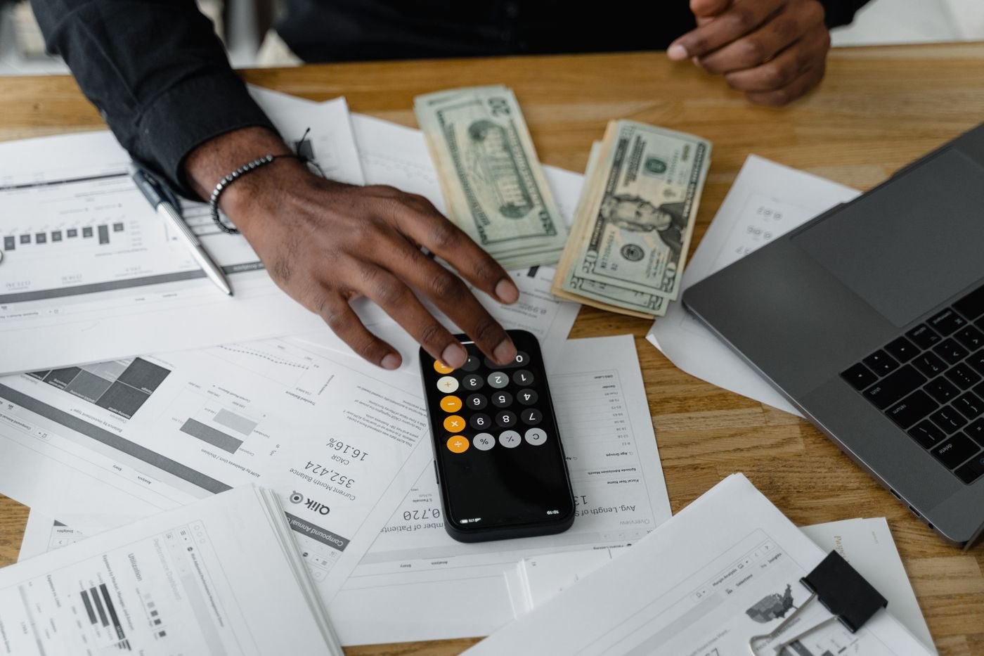 A hand checking an amount on a calculator