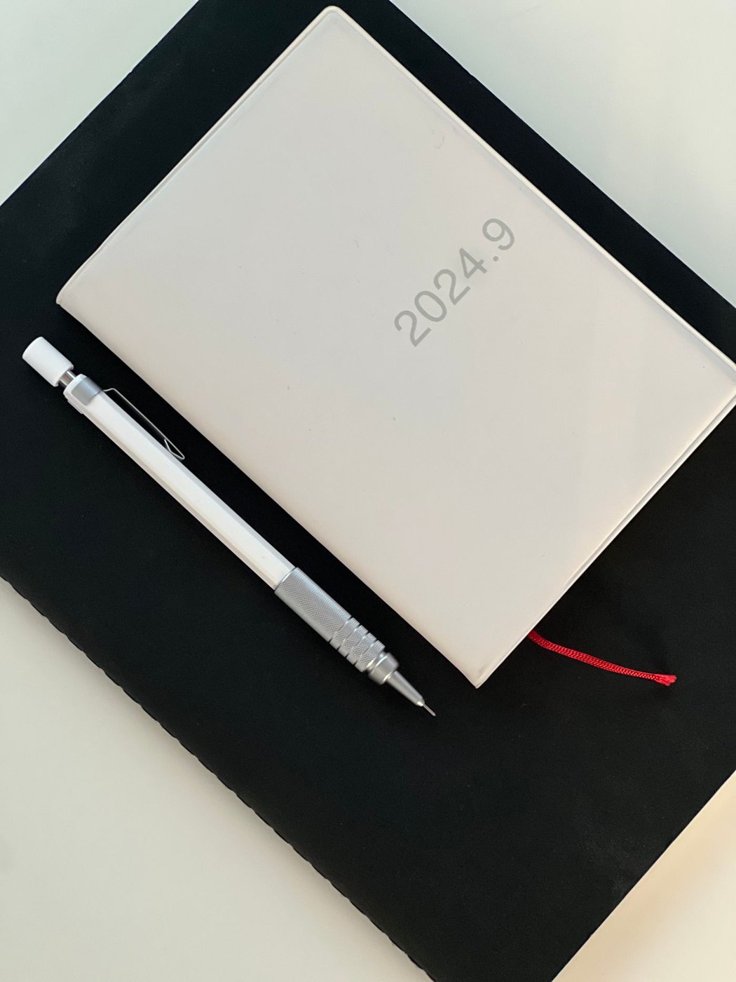 A diary beside a mechanical pencil
