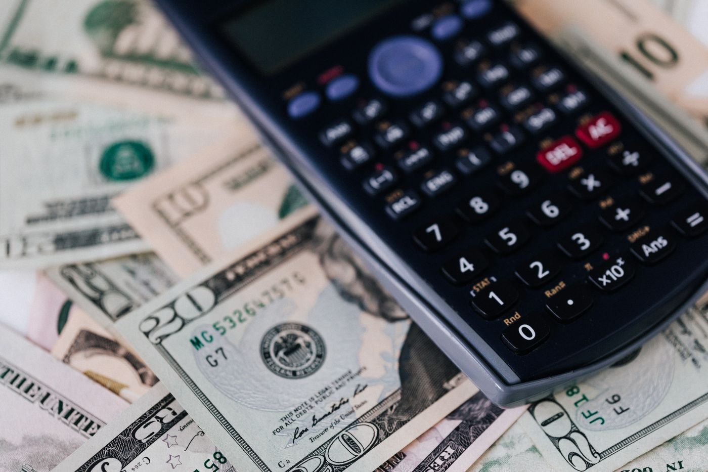 A calculator resting on banknotes