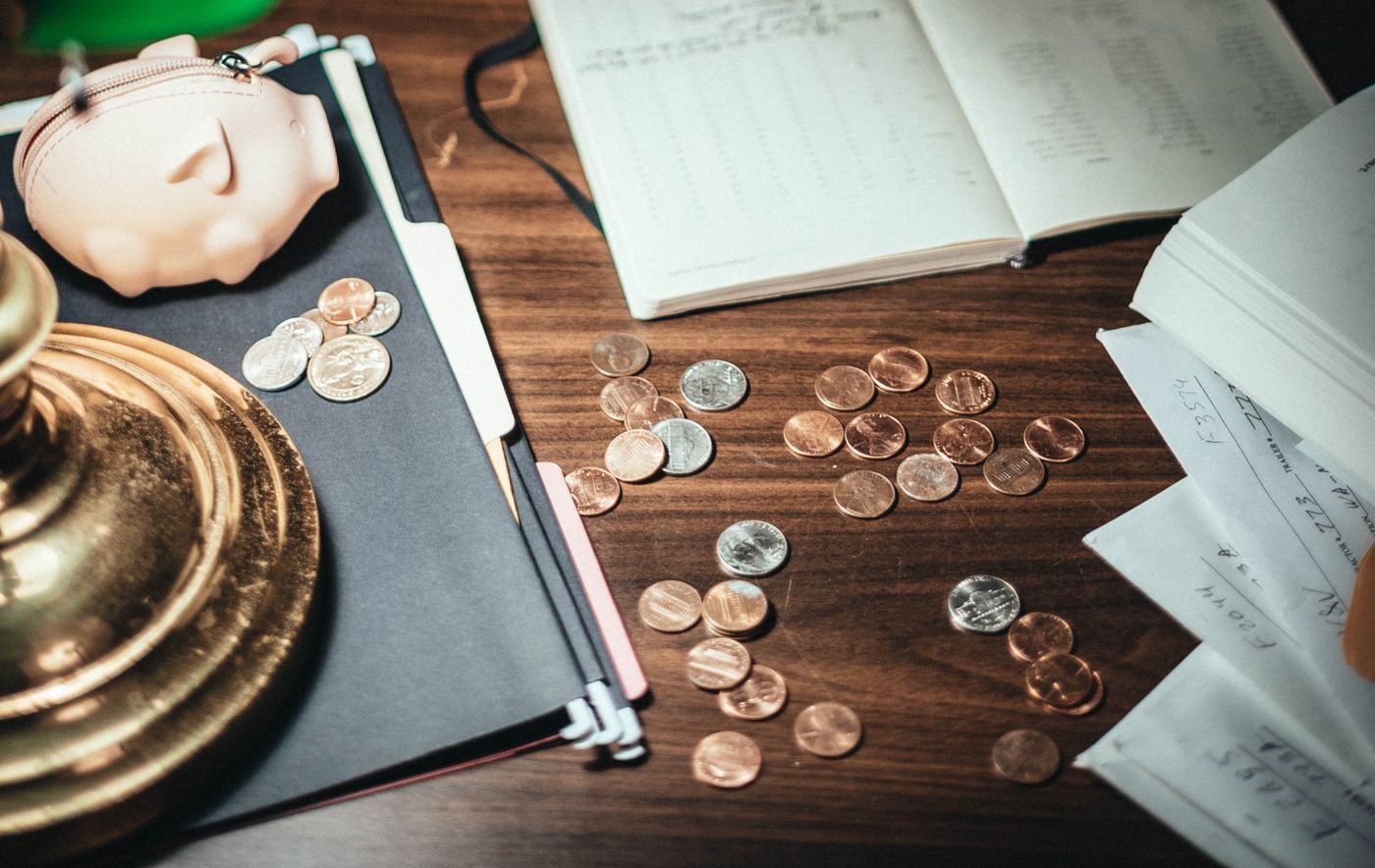 Coins and financial papers spread on a desk