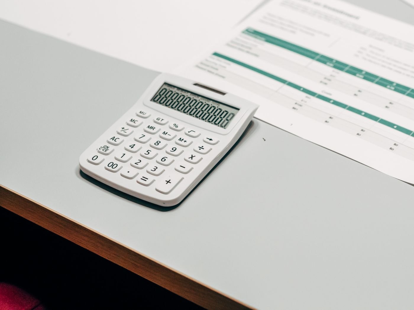 A calculator on a white work surface