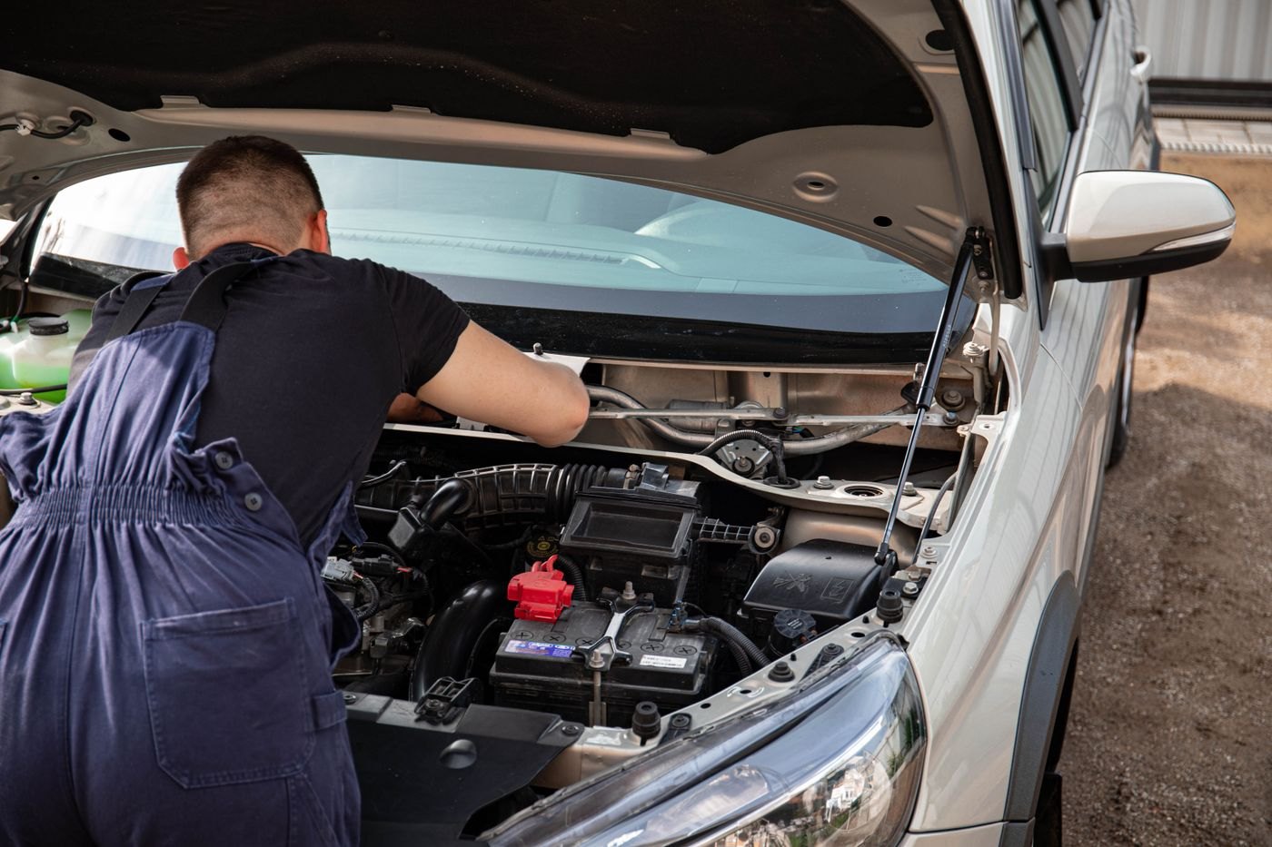 A mechanic checking a car during maintenance
