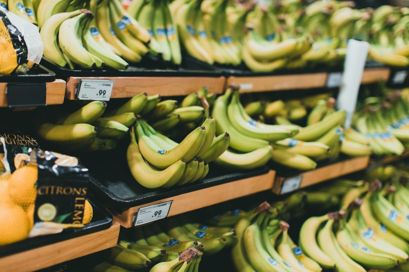 Produce on supermarket shelving with price labels