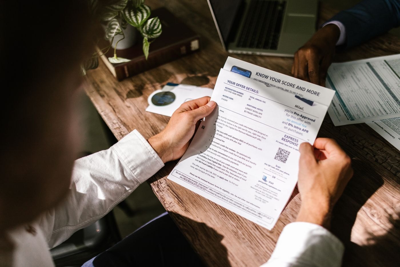 A person carefully reading a financial document
