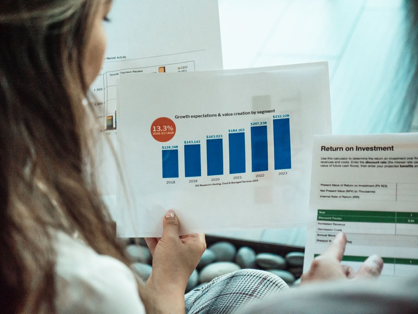 A person examining financial reports
