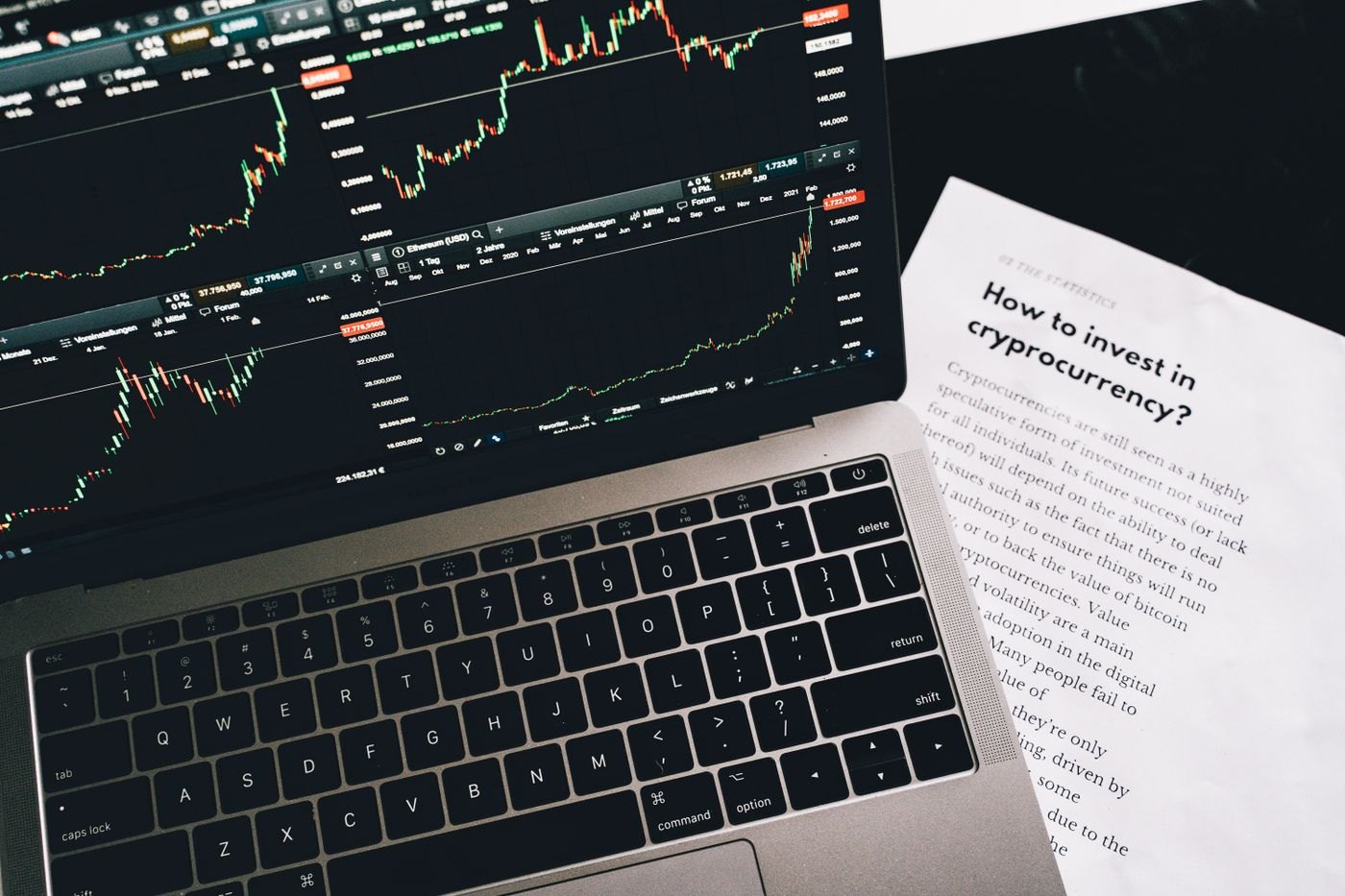 A printed report beside a laptop