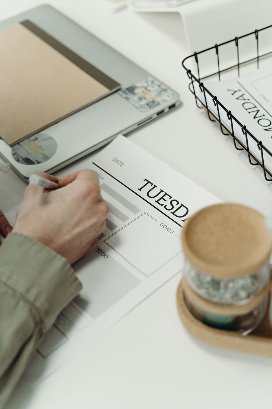 A person writing in a weekly planner