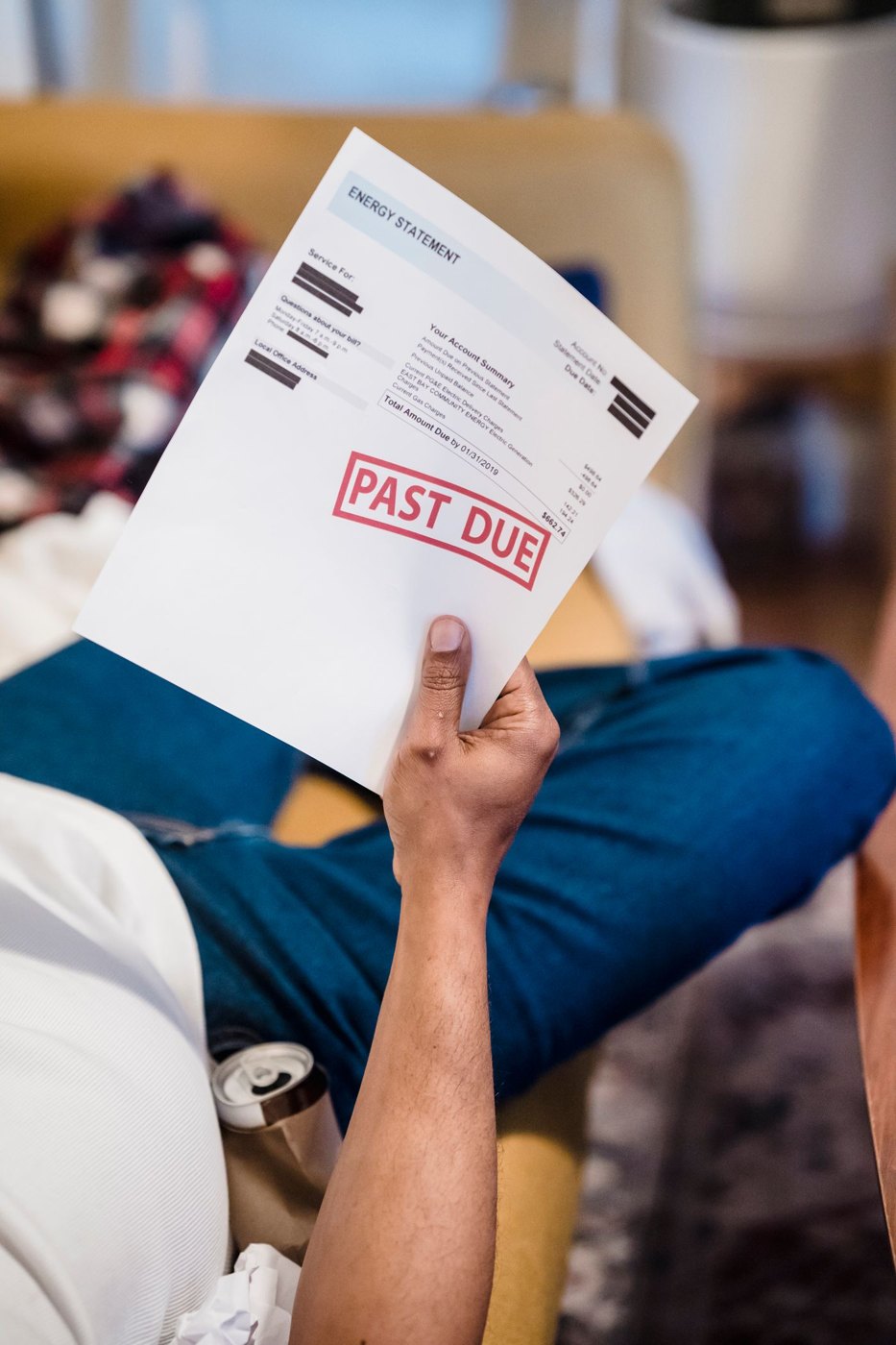 A person holding a past-due billing statement