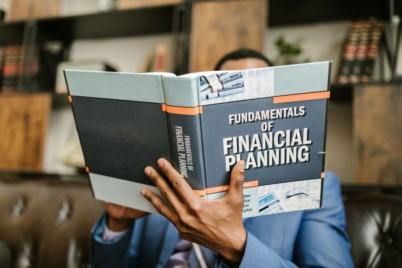 A reader holding a financial-planning book